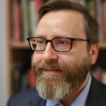 Howlett-new-profile-pic_Zachary-Moss-Howlett-scaled