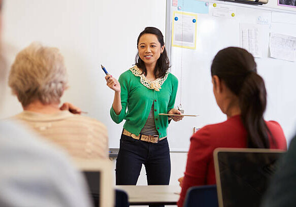 Teacher in front of students at an adult education class