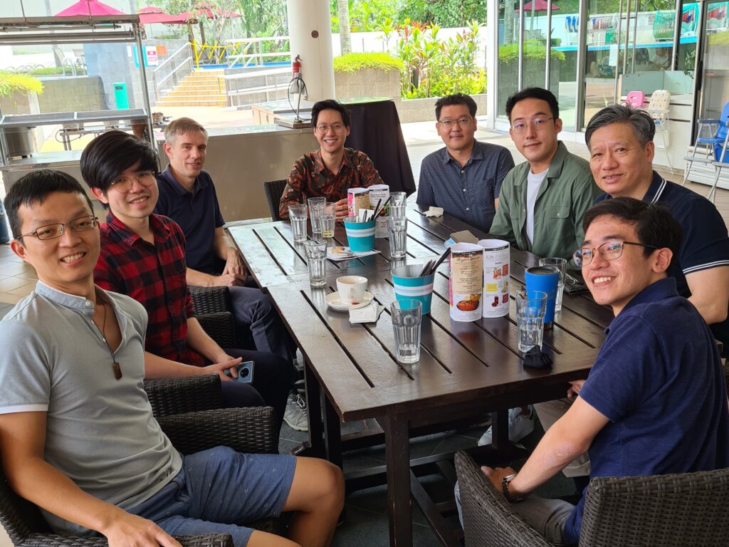 Some of the current faculty of the Department of Economics, on the steps of AS2 at Kent Ridge.