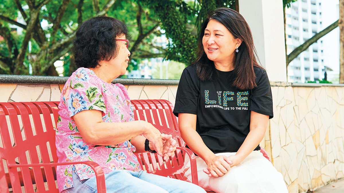 Ms Foo chatting with a senior at the MWS Active Ageing Centre at Kebun Baru.