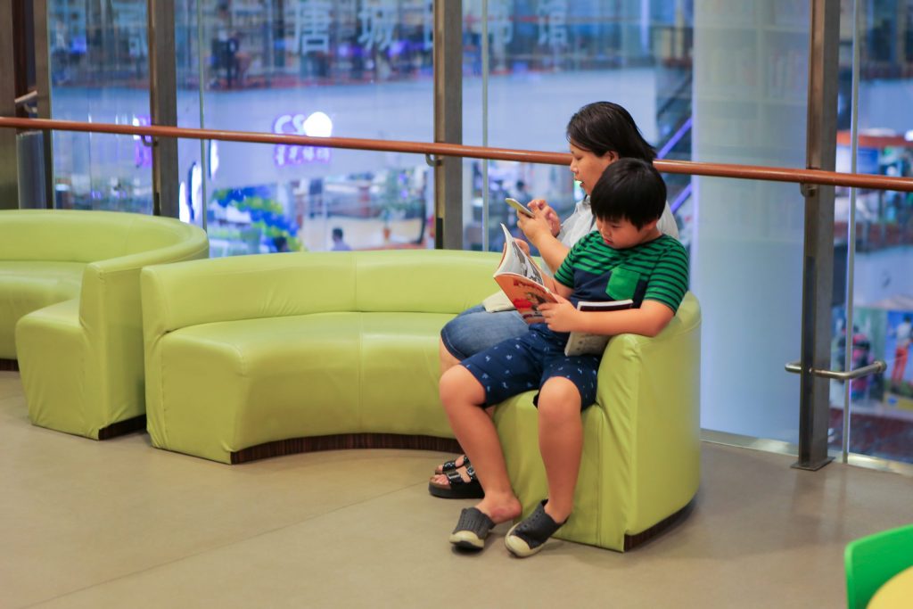 Child reading a book in the library