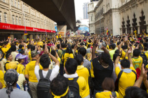 Kuala Lumpur, Malaysia - August 30, 2015: Yellow shirt Supporters cheer to speeches at Bersih 4 Rally for Free Fair Elections. Bersih organized Rallies 29/30 August 2015 in cities around Malaysia