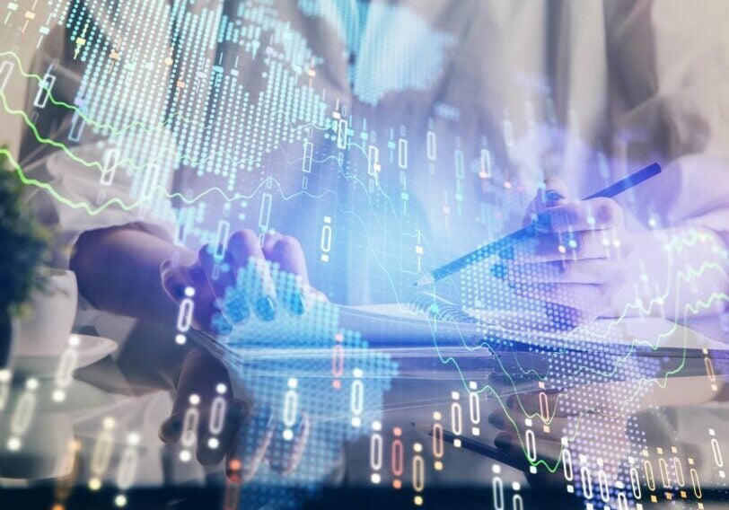 Financial forex graph drawn over hands taking notes background. Concept of research. Double exposure